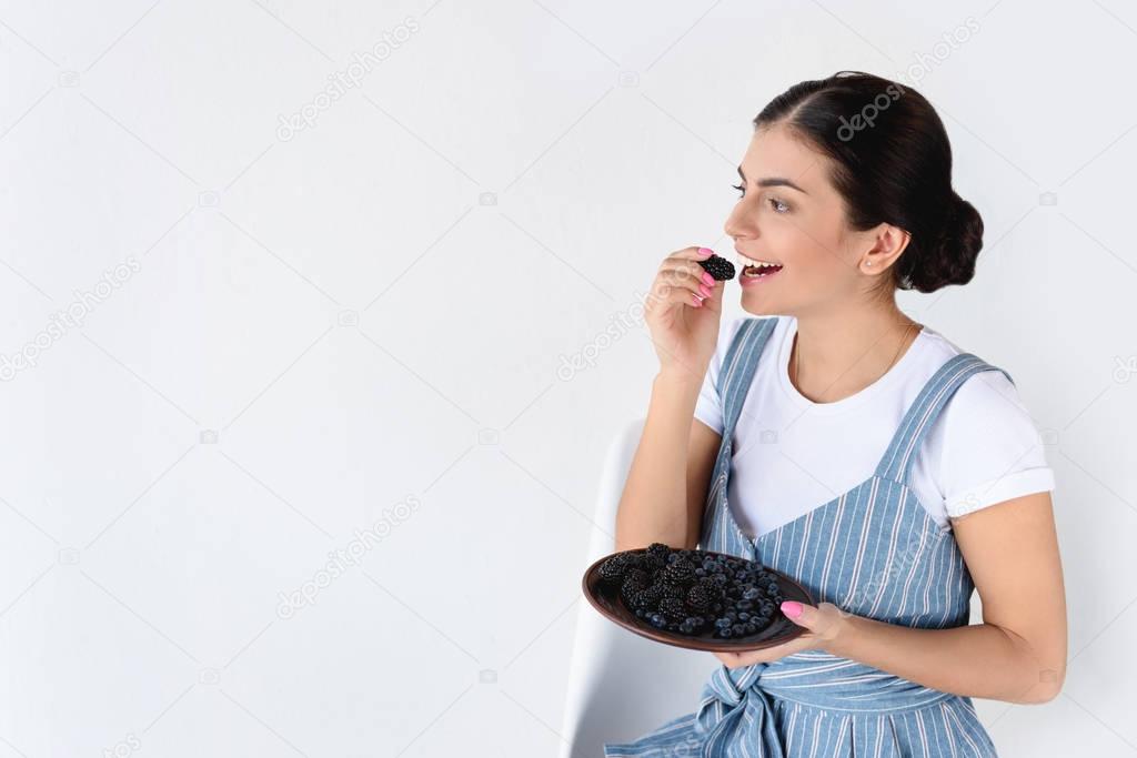 woman holding plate with berries