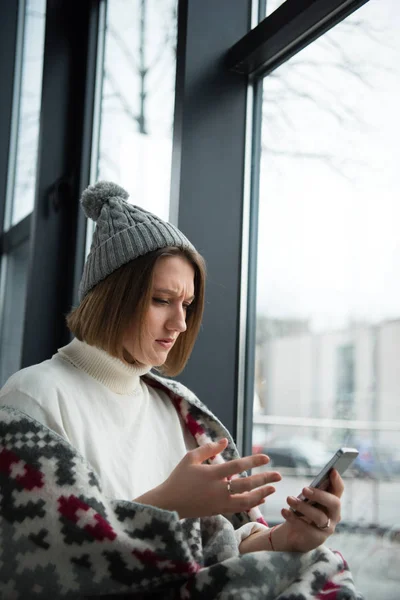 Hangsúlyozta a nő keresi a smartphone — Stock Fotó