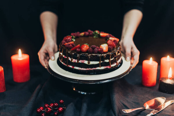 woman putting cake stand on table