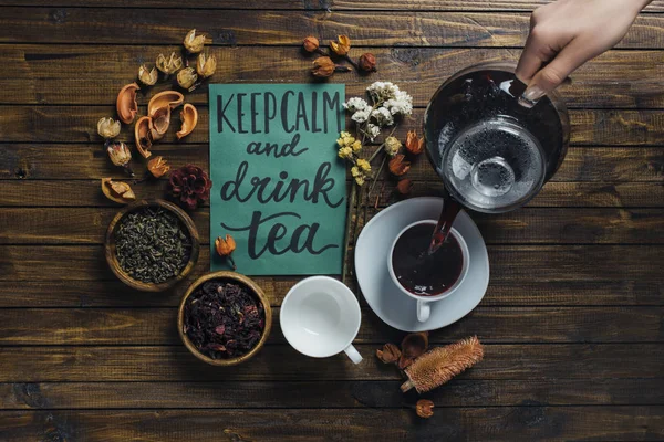 Hand with teapot and card — Stock Photo, Image