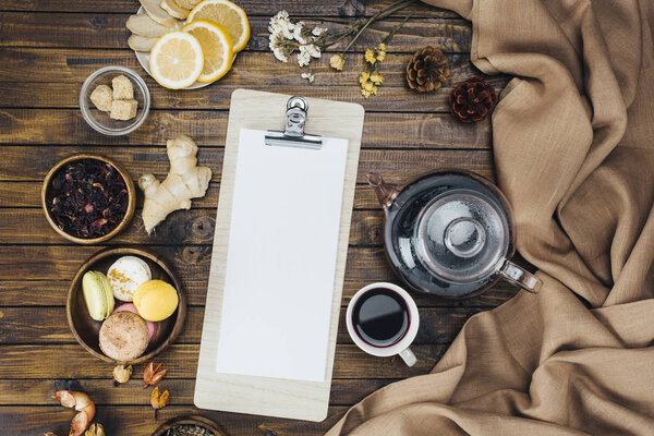 blank clipboard and tea set 