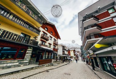 beautiful street of austrian town in mountains clipart
