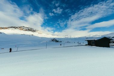 wooden shacks on beautiful mountains landscape with blue sky, Austria clipart