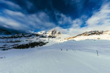 ski track on beautiful mountains landscape under blue sky, Austria clipart