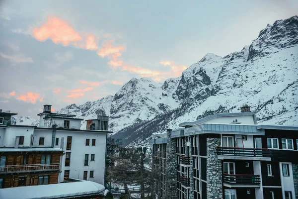 modern austrian town in mountains under sunset sky