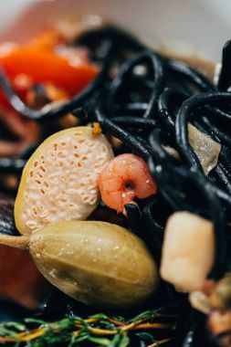 close-up view of spaghetti with cuttlefish ink, squid and mussels with octopus clipart