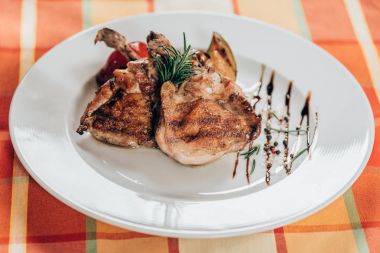 delicious grilled chicken with rosemary and sauce on plate  clipart