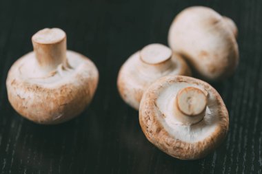 close-up view of fresh ripe mushrooms on wooden table clipart