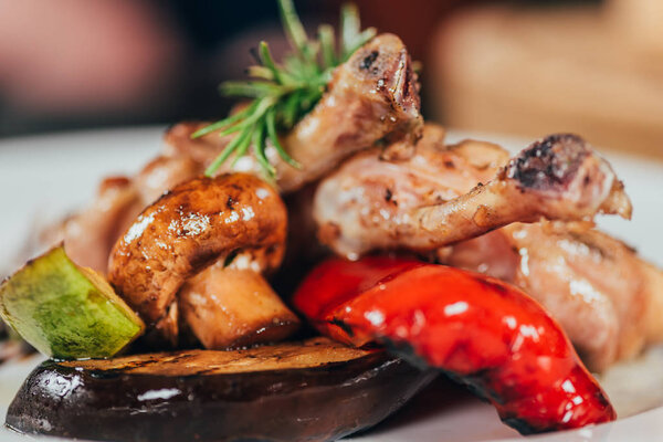 close-up view of gourmet grilled chicken with mushroom, pepper, rosemary, zucchini and eggplant