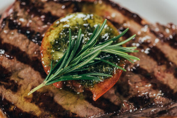 close-up view of delicious roasted juicy beef steak with rosemary