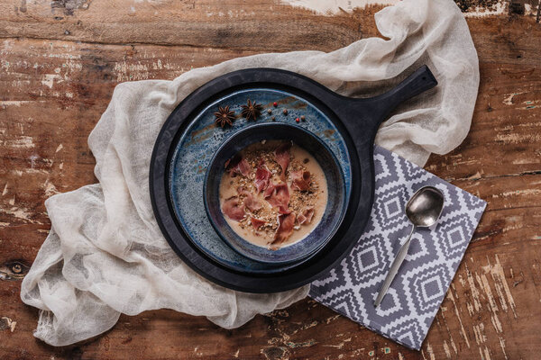 top view of delicious cream soup with jamon and fried potatoes