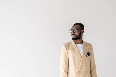 portrait of handsome young stylish african american man in eyeglasses looking away isolated on grey