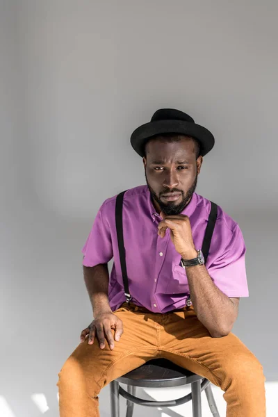 Portrait Thoughtful African American Man Stylish Hat Sitting Chair Grey — Stock Photo, Image