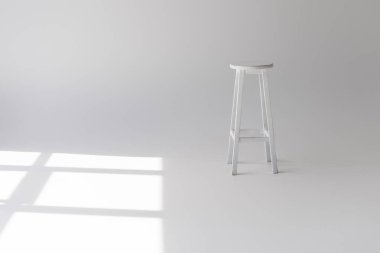 single empty modern white stool on grey clipart