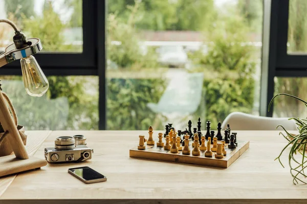 Chess game with vintage camera — Stock Photo