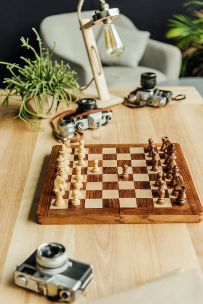 Chess board set with old cameras — Stock Photo