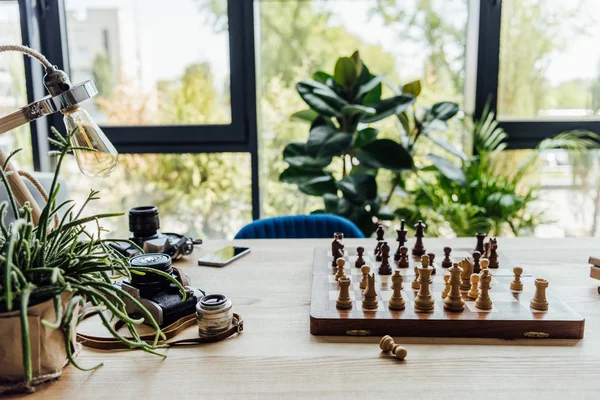 Chess board set with old cameras — Stock Photo