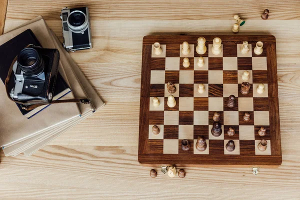 Chess board set with old cameras — Stock Photo