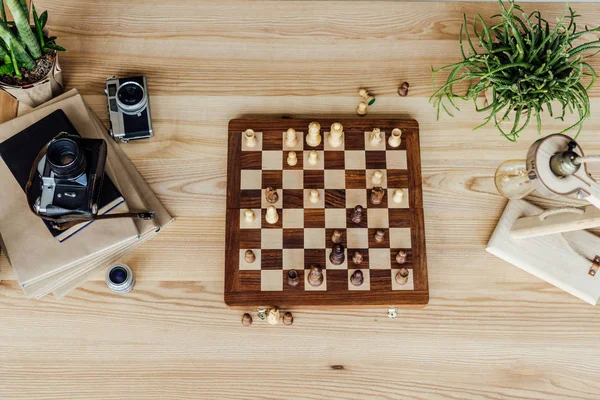 Chess board set with old cameras — Stock Photo