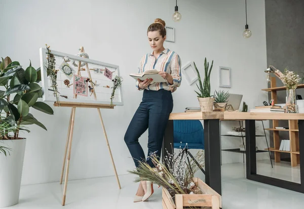 Donna d'affari con libro in ufficio — Foto stock