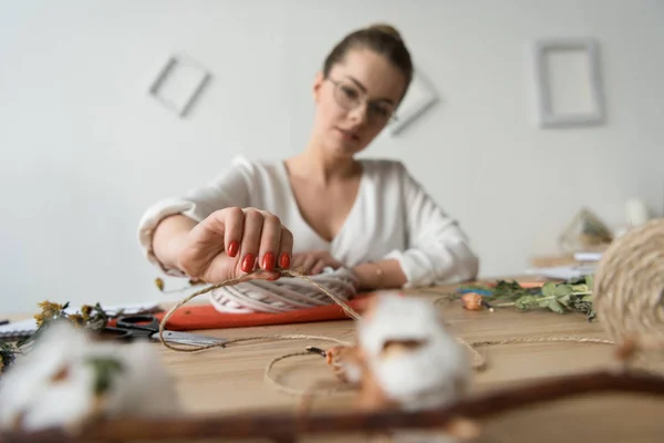 Designer with twine at workplace — Stock Photo