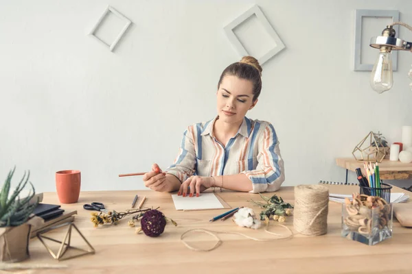 Decorador escribiendo en el lugar de trabajo - foto de stock