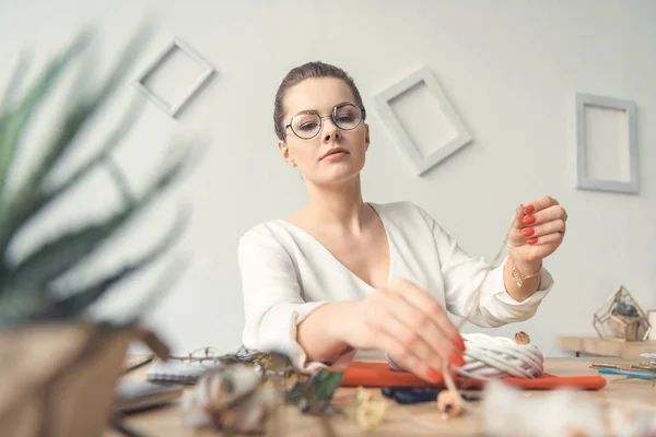 Florist with twine at workplace — Stock Photo