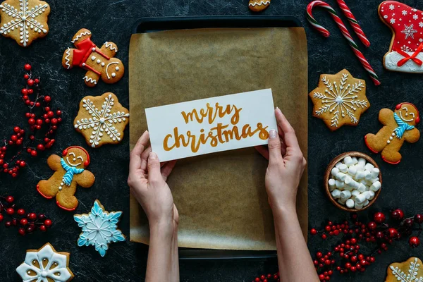 Christmas gingerbreads and greeting card — Stock Photo