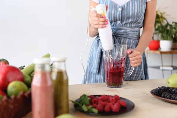 Woman cooking detox drink — Stock Photo