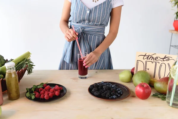 Woman with detox drink on table — Stock Photo