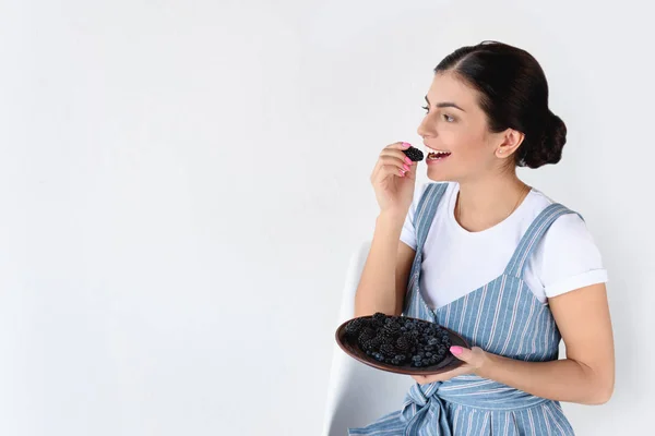 Woman holding plate with berries — Stock Photo