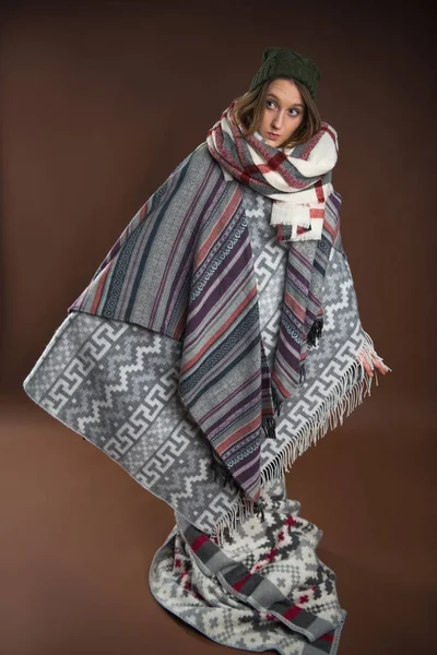 Girl standing wrapped in warm blankets — Stock Photo