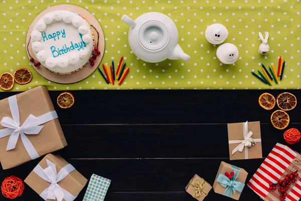 Present boxes and birthday cake — Stock Photo