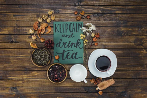 Cups, dry tea and card — Stock Photo