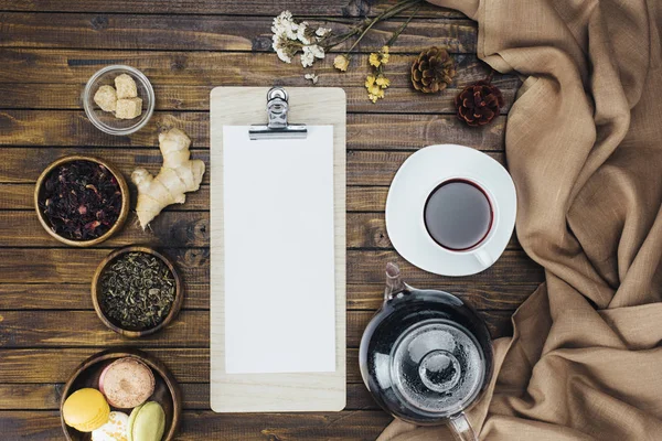 Tea set and blank clipboard — Stock Photo