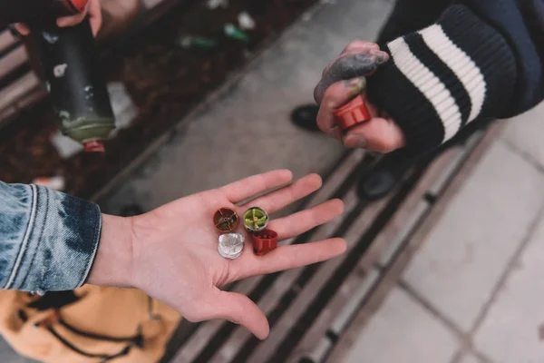 Cropped view of street artists holding can with spray paint and tools — Stock Photo