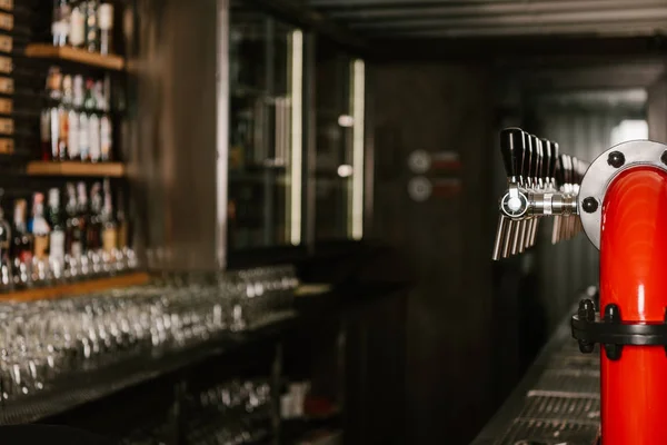 Beer pipe taps in modern pub — Stock Photo