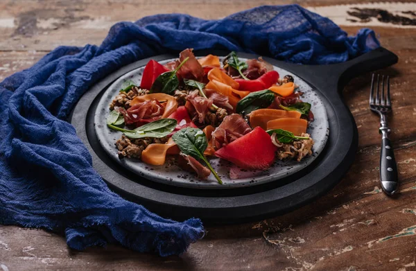 Close-up view of fresh gourmet salad with mussels, vegetables and jamon on wooden table — Stock Photo