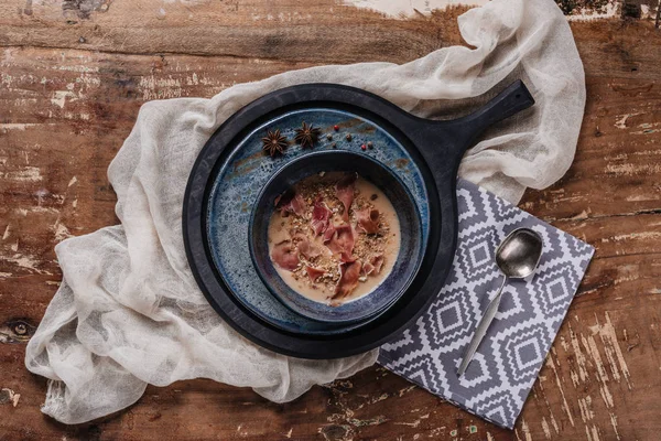 Top view of delicious cream soup with jamon and fried potatoes — Stock Photo