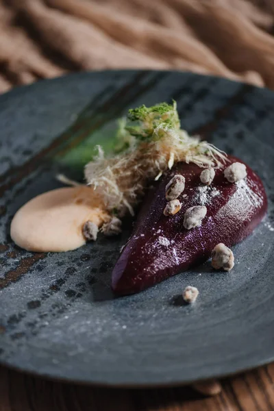 Close-up view of gourmet pear in wine with caramelized pistachios — Stock Photo