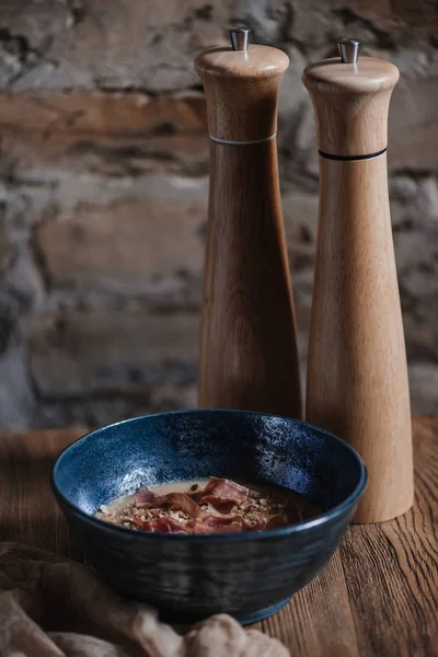 Close-up view of bowl with gourmet cream soup with jamon — Stock Photo