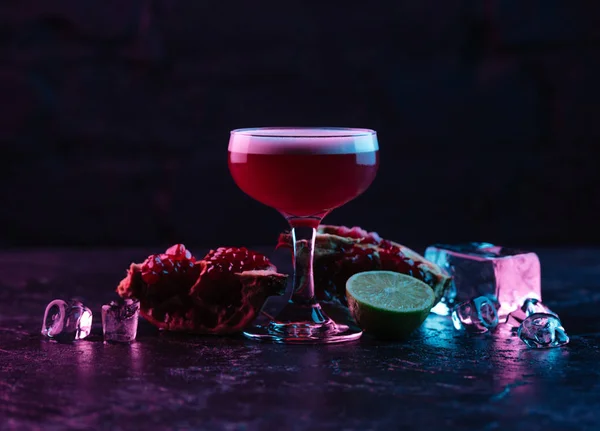 Close-up view of glass with delicious conchita cocktail and ingredients on dark surface — Stock Photo