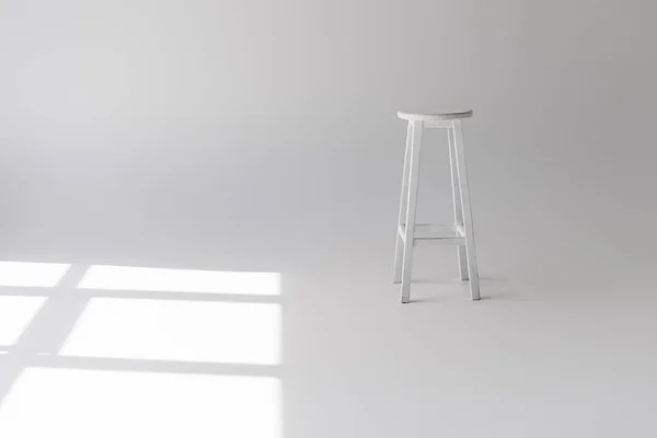 Single empty modern white stool on grey — Stock Photo
