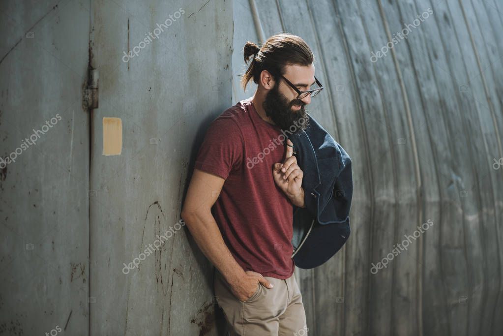 Man leaning back on old hangar