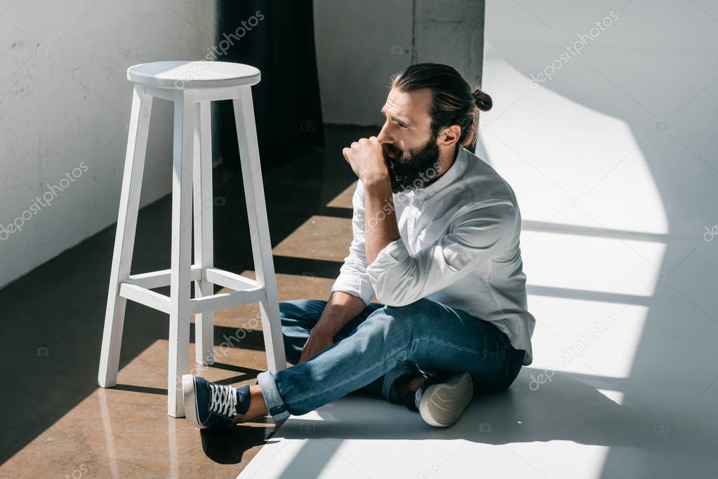 handsome man sitting on floor