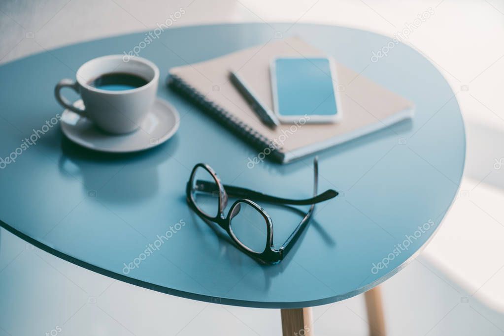 coffee, notepad and eyeglasses