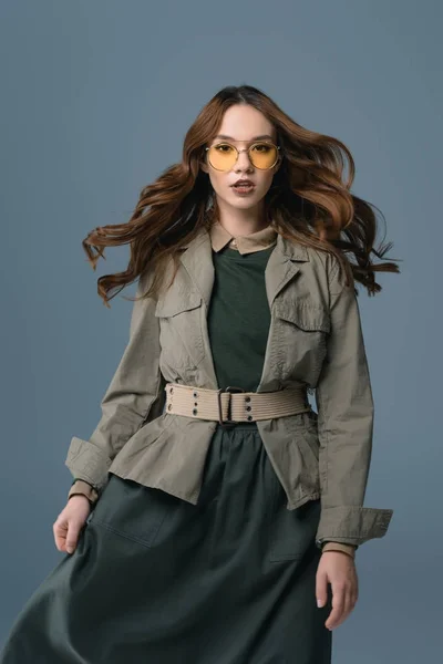 Beautiful stylish girl posing in autumn outfit for fashion shoot, isolated on grey — Stock Photo