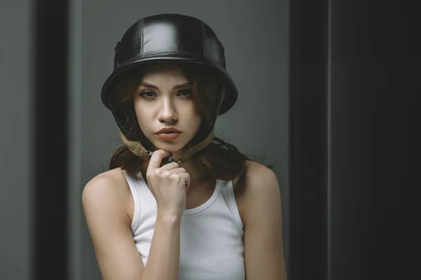 Thoughtful young girl in military helmet for fashion shoot — Stock Photo