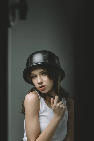 Attractive young model posing in military helmet for fashion shoot — Stock Photo