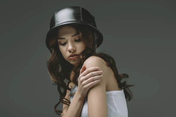 Beautiful young girl in military helmet, isolated on grey — Stock Photo